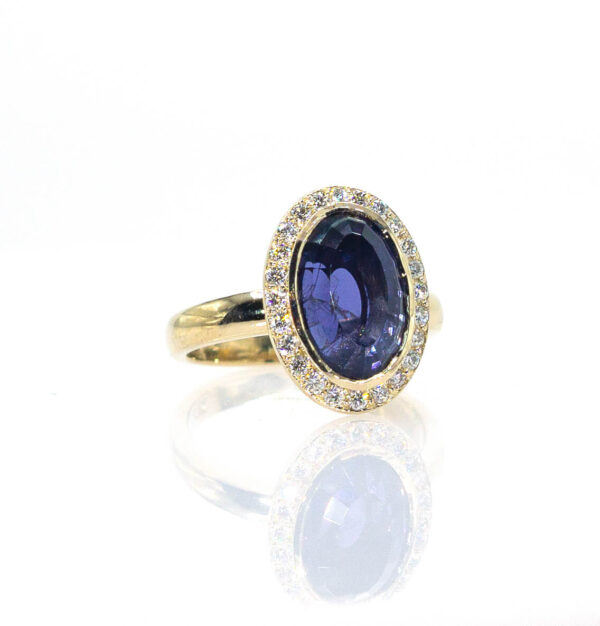 3.73 Ct Custom Cut Iolite surrounded by .36 Ct of Diamonds set in a Custom 14K Gold Mounting