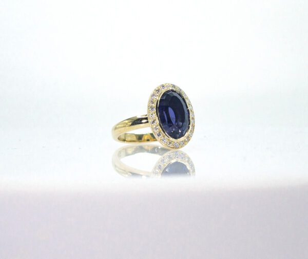 3.73 Ct Custom Cut Iolite surrounded by .36 Ct of Diamonds set in a Custom 14K Gold Mounting