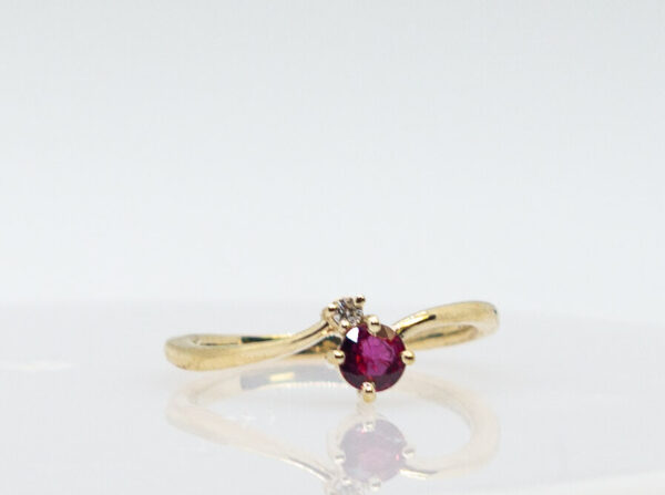 .33 Ct Round Natural Ruby flanked by a .015 Ct Diamond in 14K Gold