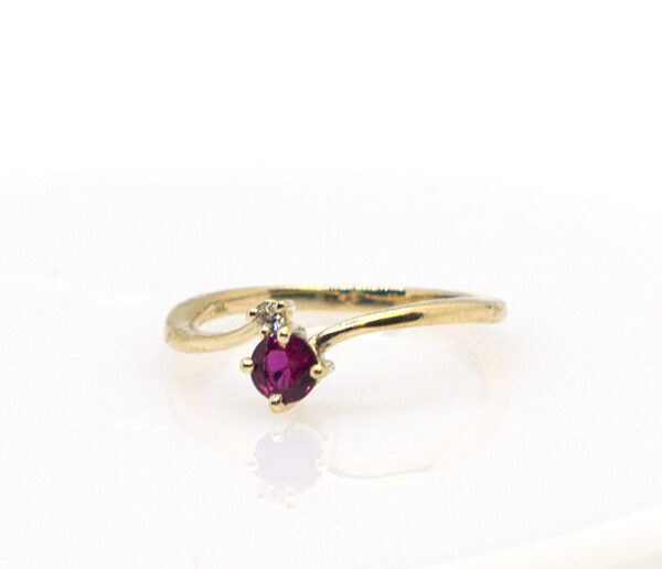 .33 Ct Round Natural Ruby flanked by a .015 Ct Diamond in 14K Gold